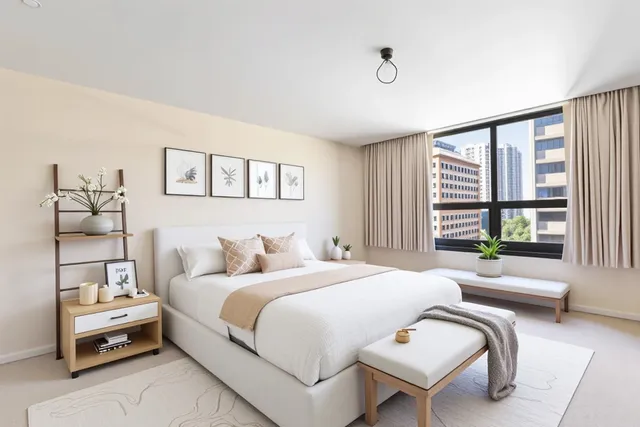 a bedroom with a bed and a large window