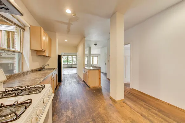 a view of a kitchen with a stove top oven