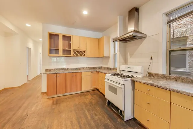 a kitchen with a stove oven and a sink