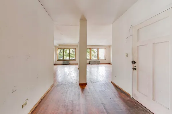 a view of an entryway with wooden floor