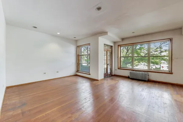 wooden floor in an empty room with a window