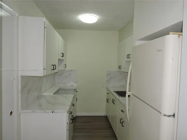 a bathroom with a shower and a sink