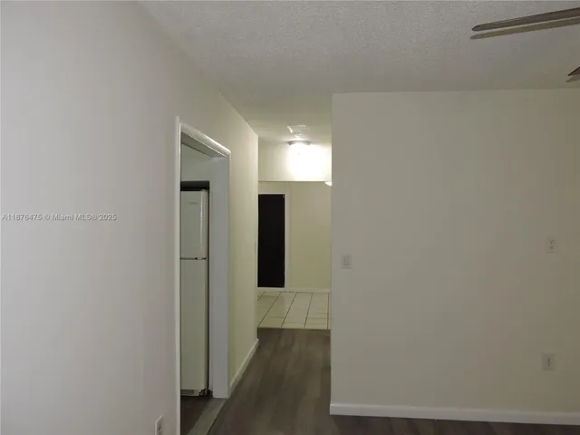 a view of hallway with wooden floor