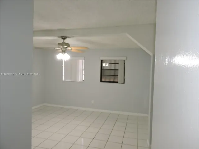 a view of an empty room with a fan