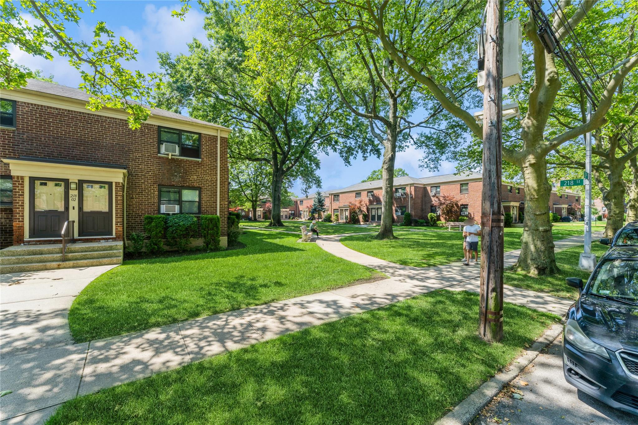 217-22 73rd Avenue, Unit UPPR Queens, NY 11364 - Photo 11 of 17 View of home's community featuring a lawn and entry steps