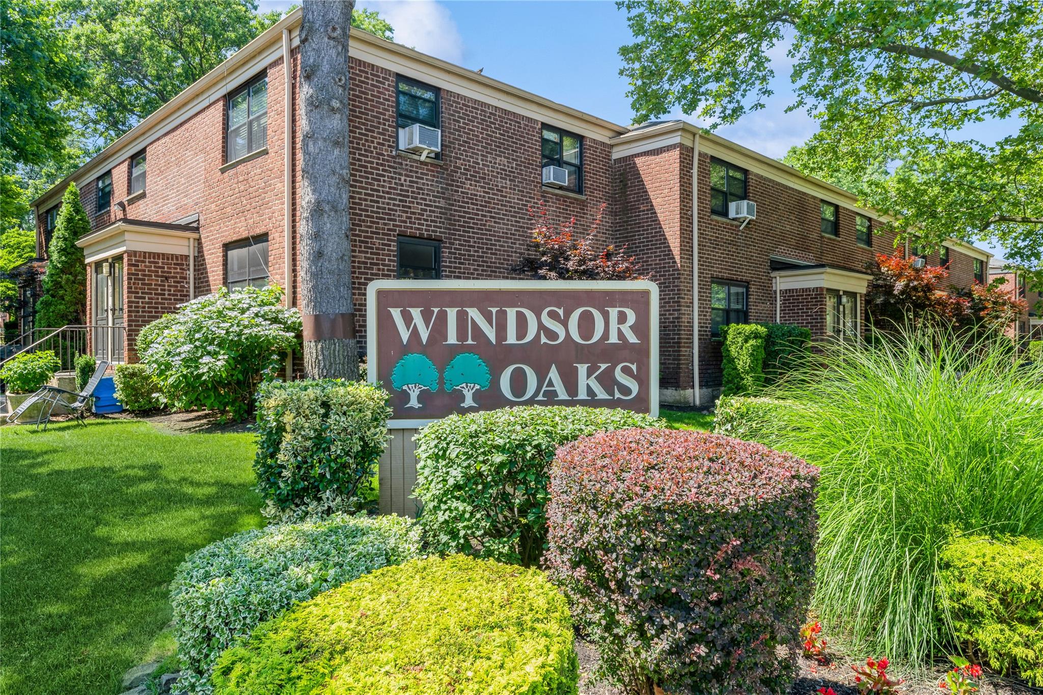 217-22 73rd Avenue, Unit UPPR Queens, NY 11364 - Photo 16 of 17 Community sign featuring a lawn