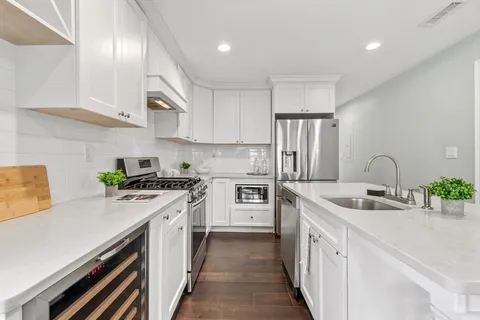 a kitchen with a sink stove and refrigerator