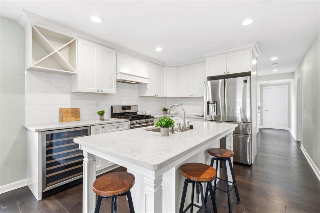 63 Century Street, Unit 2 Medford, MA 02155 - Photo 13 of 35 a kitchen with stainless steel appliances a table and chairs in it
