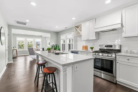 a kitchen with stainless steel appliances granite countertop a stove and a refrigerator