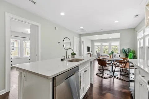 a view of a kitchen area with furniture and wooden floor
