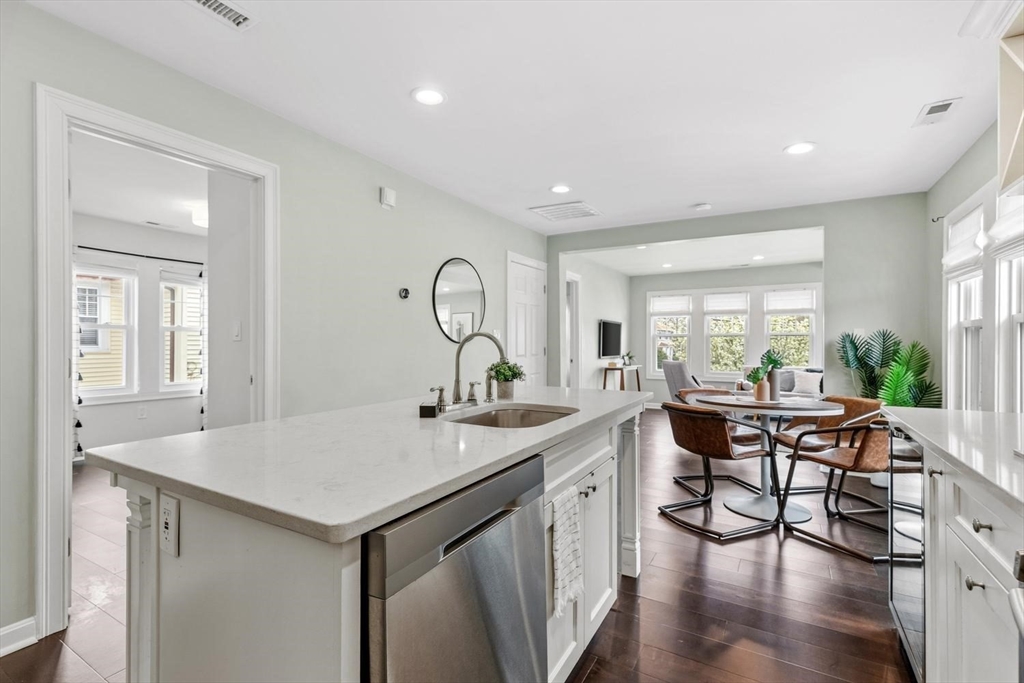 63 Century Street, Unit 2 Medford, MA 02155 - Photo 16 of 35 a view of a kitchen area with furniture and wooden floor