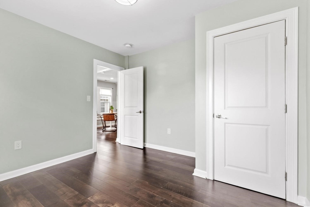 63 Century Street, Unit 2 Medford, MA 02155 - Photo 19 of 35 a view of an empty room with wooden floor