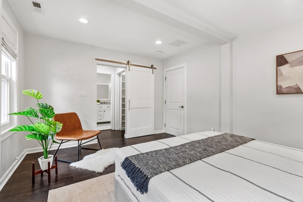 63 Century Street, Unit 2 Medford, MA 02155 - Photo 25 of 35 a bedroom with a bed and furniture