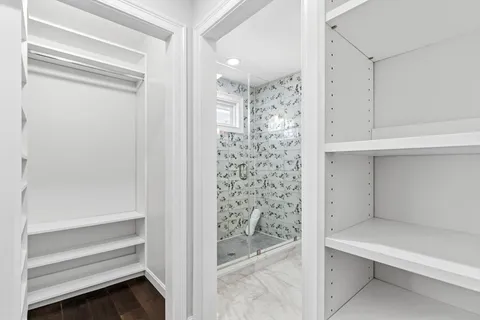 a room with white cabinets and window