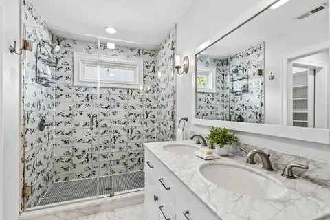 a bathroom with a sink toilet and shower
