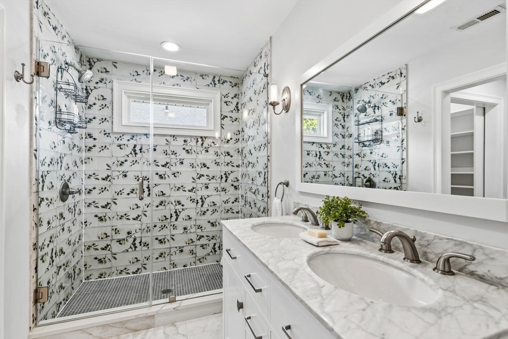 63 Century Street, Unit 2 Medford, MA 02155 - Photo 30 of 35 a bathroom with a granite countertop sink a mirror a shower and a bathtub