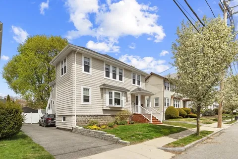 a front view of a house with a garden