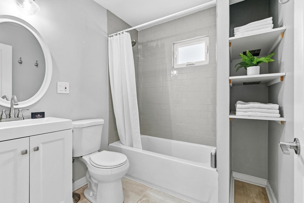 63 Century Street, Unit 2 Medford, MA 02155 - Photo 31 of 35 a bathroom with a sink toilet and shower