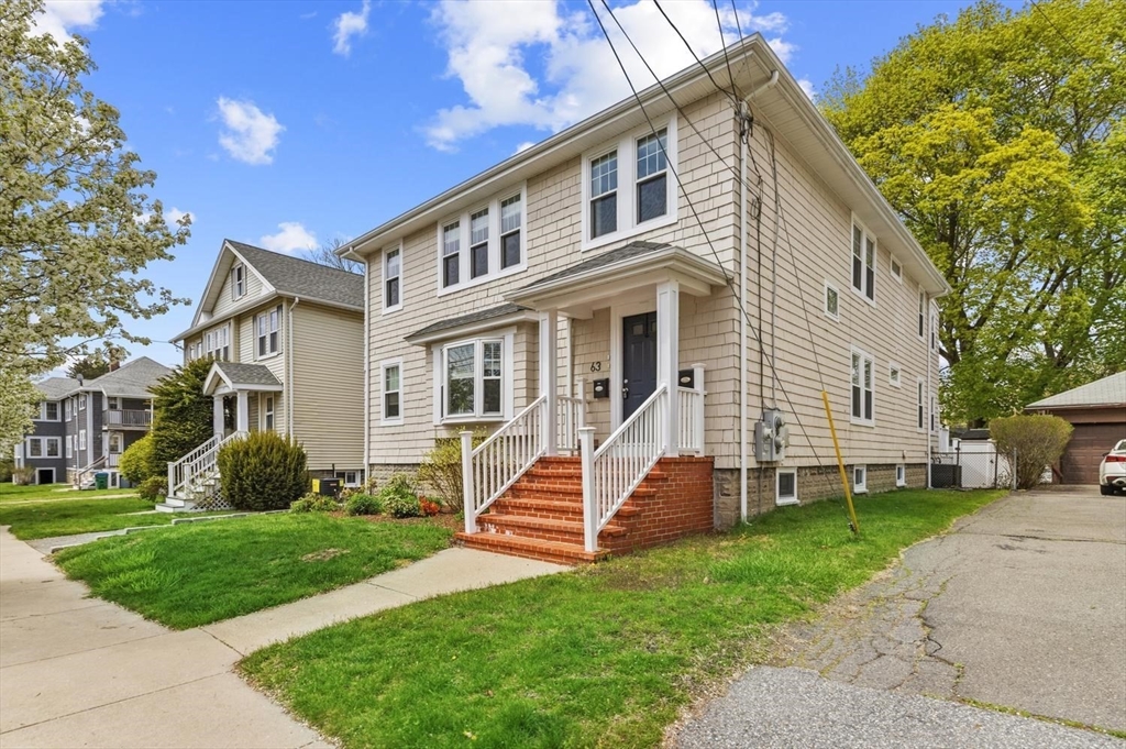 63 Century Street, Unit 2 Medford, MA 02155 - Photo 4 of 35 a front view of a house with a yard