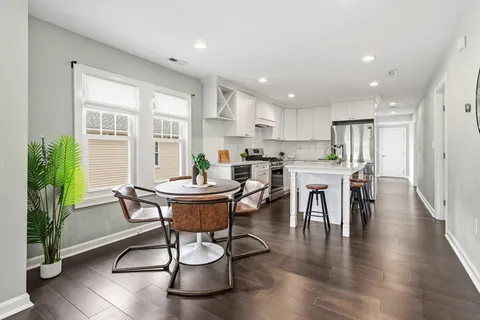a living room with furniture wooden floor and a table