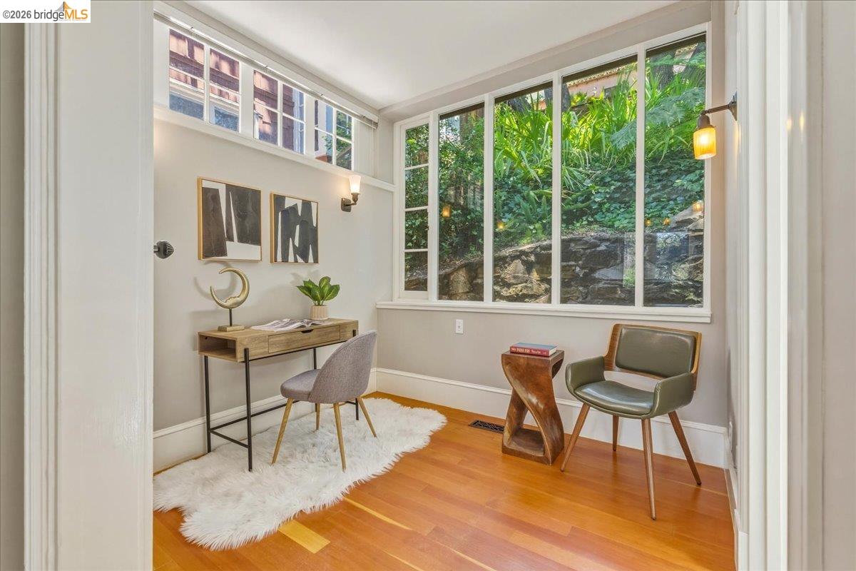 1631 La Vereda Road Berkeley, CA 94709 - Photo 22 of 42 Hardwood flooring complemented by a large window with multiple panes, transom window, and light gray wall paint