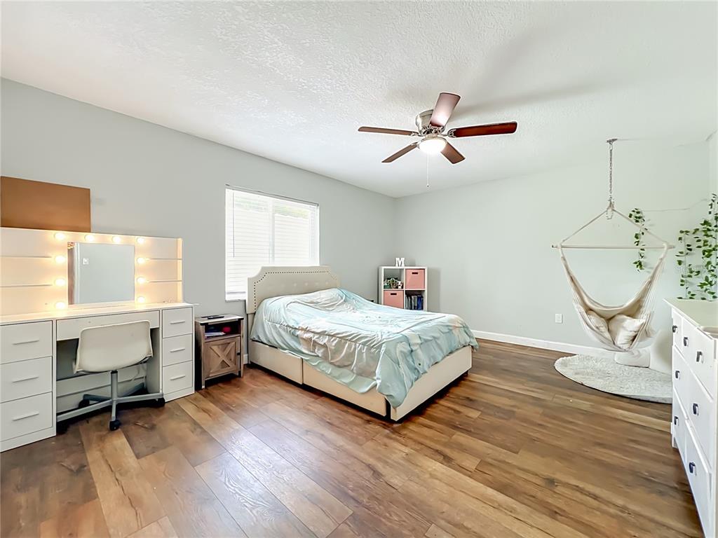 153 Variety Tree Circle Altamonte Springs, FL 32714 - Photo 27 of 44 a bedroom with a bed and a chandelier