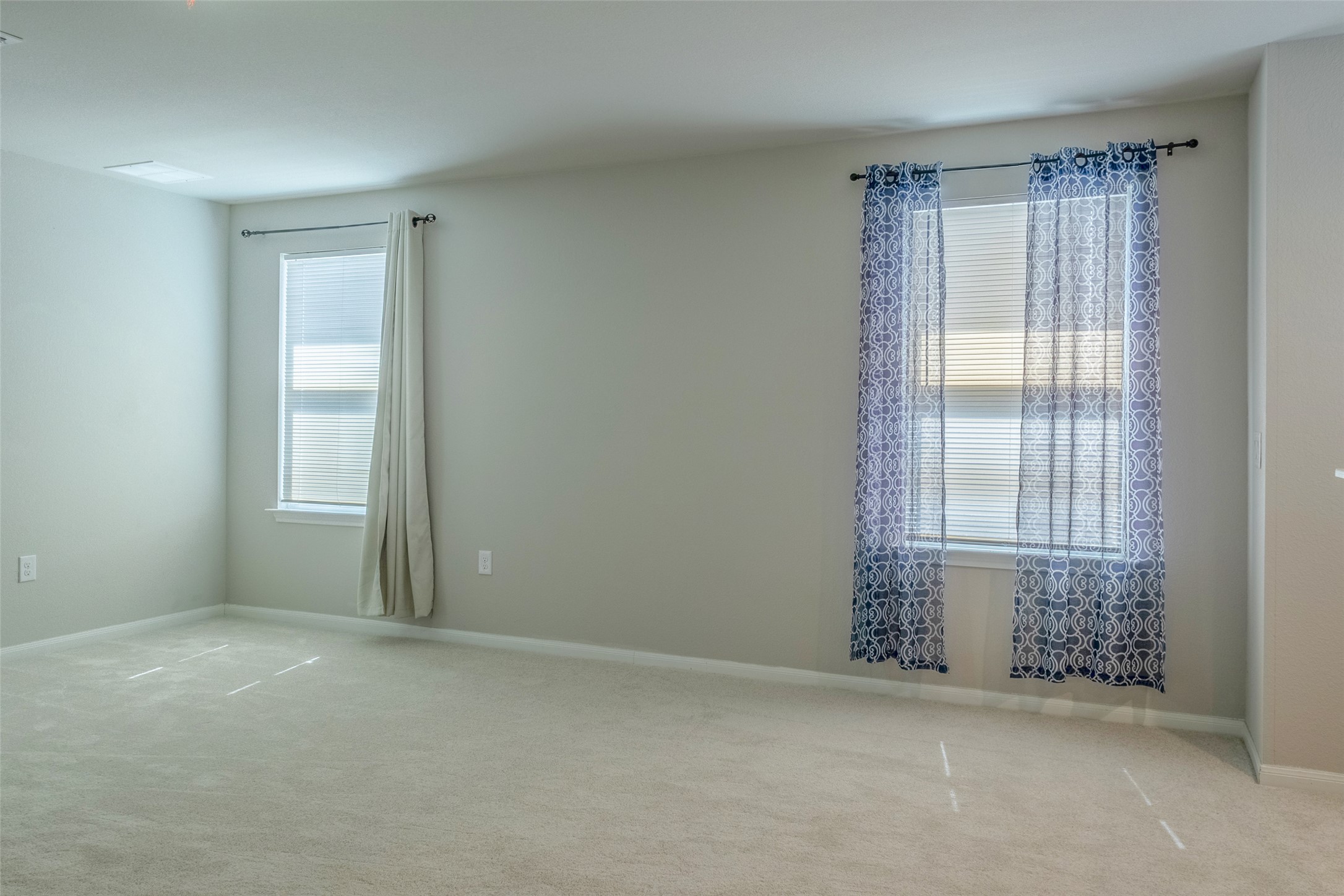 7225 Ranchito Drive Austin, TX 78744 - Photo 20 of 39 A quiet retreat with well-lit walls and soft carpet, ready for personalization.