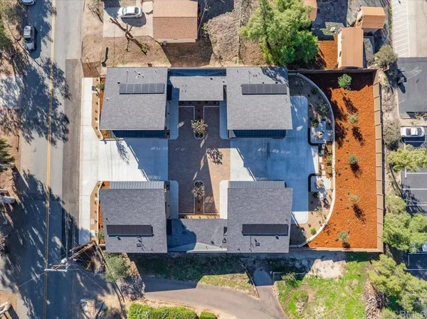 an aerial view of residential houses with outdoor space