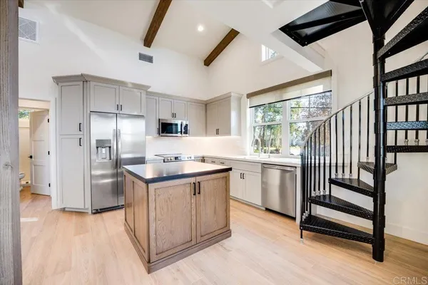 a kitchen with appliances cabinets and a sink
