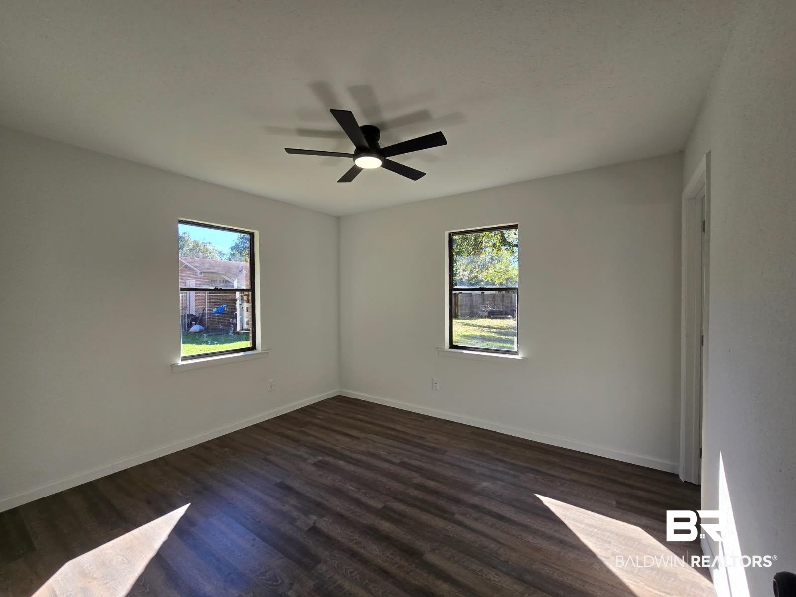 1404 Dailey Street Brewton, AL 36426 - Photo 20 of 25 Unfurnished room with dark wood finished floors and ceiling fan