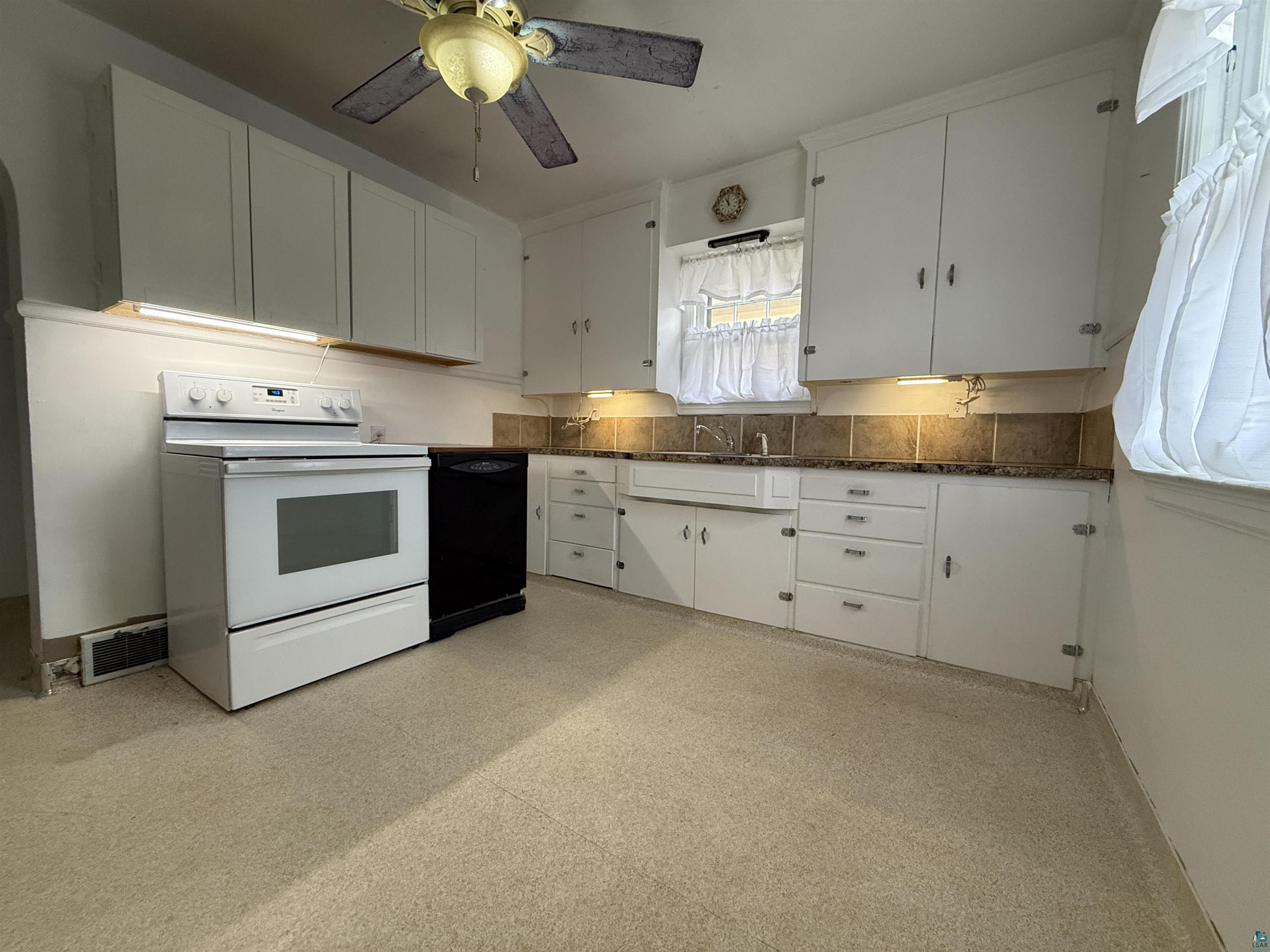 3001 3rd Avenue West Hibbing, MN 55746 - Photo 16 of 38 Kitchen featuring light floors, white cabinets, white range with electric cooktop, ceiling fan, and dishwasher