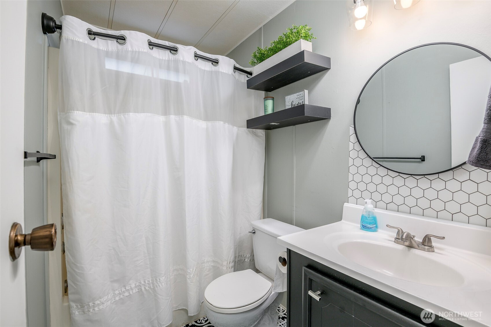 201 Union Avenue Southeast, Unit 157 Renton, WA 98059 - Photo 21 of 33 a bathroom with a sink toilet and shower