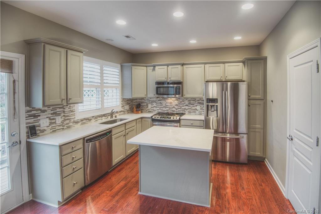 581 6th Baxter Crossing, Unit 1 Fort Mill, SC 29708 - Photo 11 of 34 a kitchen with stainless steel appliances a refrigerator sink and microwave