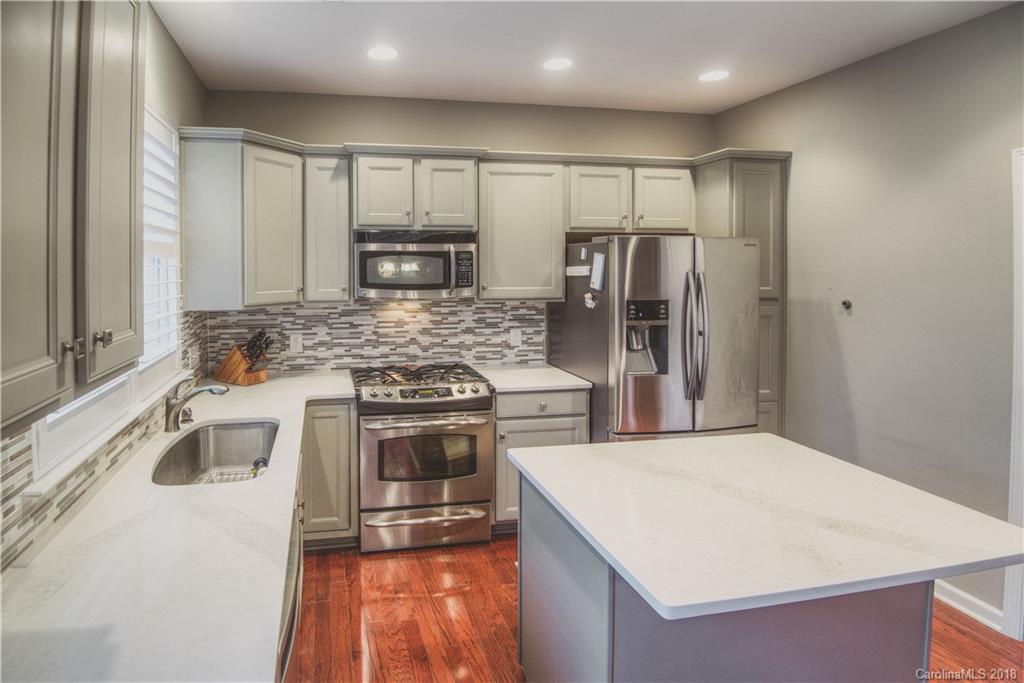 581 6th Baxter Crossing, Unit 1 Fort Mill, SC 29708 - Photo 12 of 34 a kitchen with stainless steel appliances granite countertop a sink stove and refrigerator