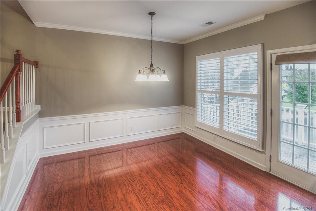 581 6th Baxter Crossing, Unit 1 Fort Mill, SC 29708 - Photo 13 of 34 a view of an empty room with wooden floor and a window