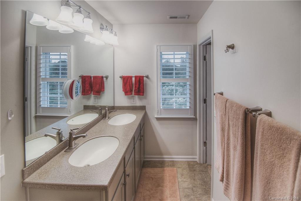 581 6th Baxter Crossing, Unit 1 Fort Mill, SC 29708 - Photo 16 of 34 a bathroom with a sink double vanity and a shower