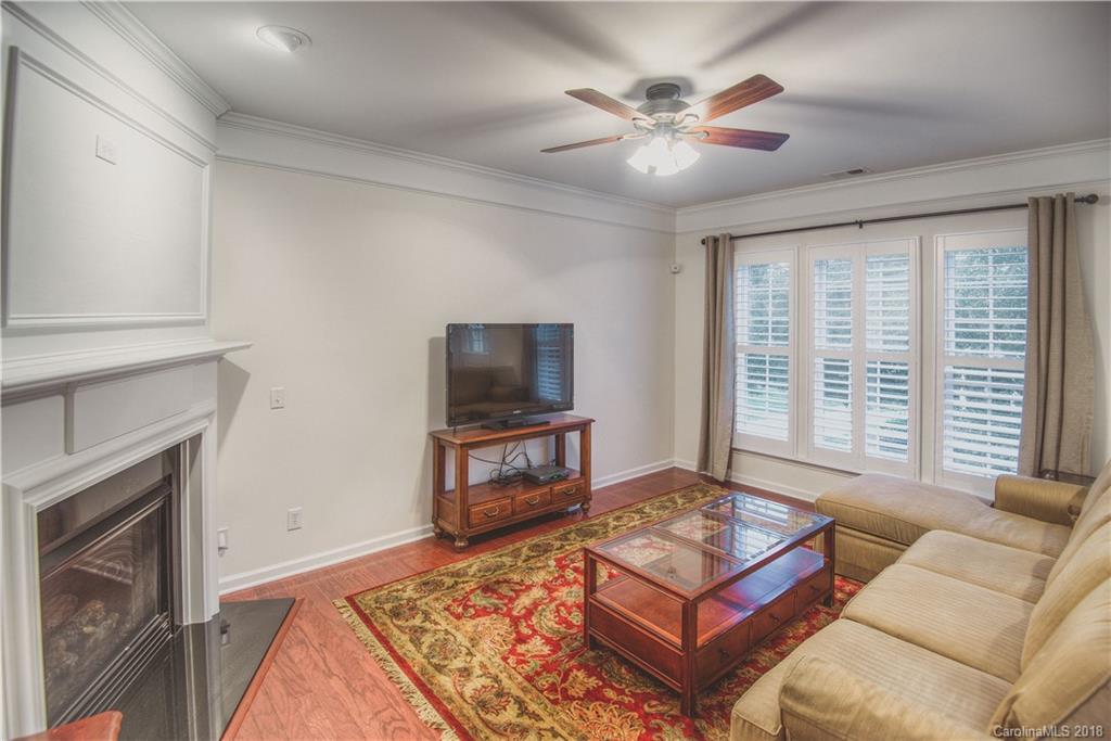 581 6th Baxter Crossing, Unit 1 Fort Mill, SC 29708 - Photo 8 of 34 a living room with furniture and a flat screen tv