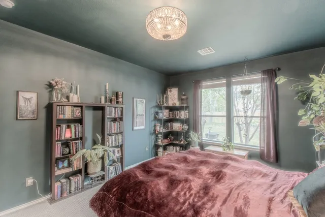 a bedroom with a bed furniture and a window
