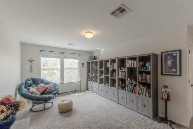 a living room with furniture cabinets and window