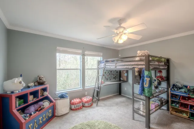 a children room with toys and a chandelier fan