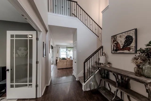 a view of staircase with wooden floor and painting on the wall