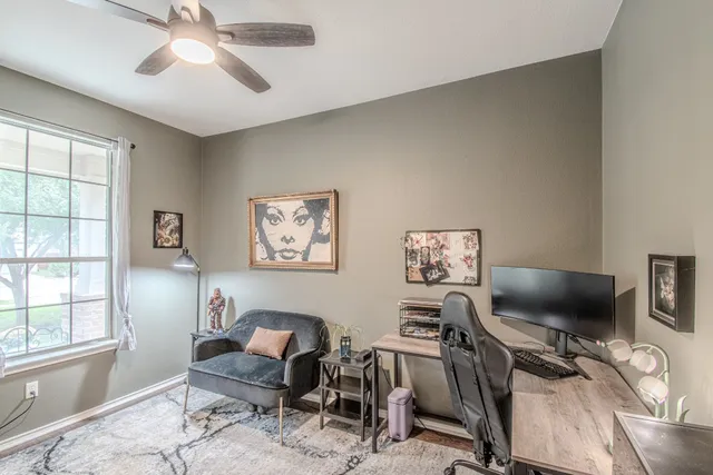 a view of a livingroom with workspace and a window