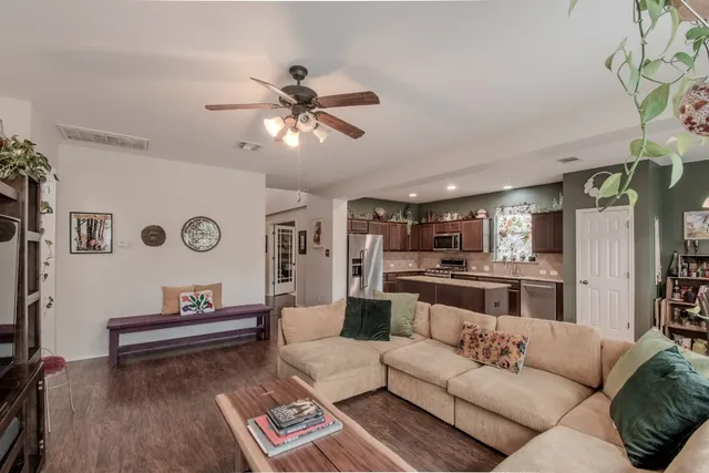 a living room with furniture and a wooden floor