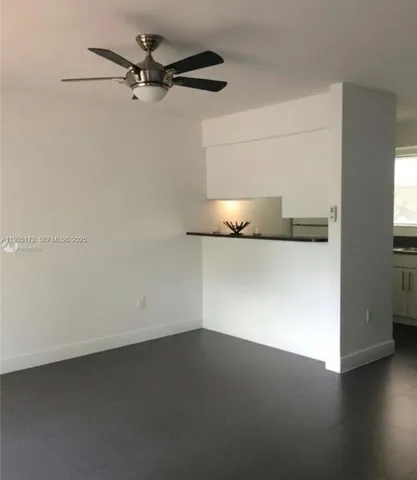 an empty room with a kitchen