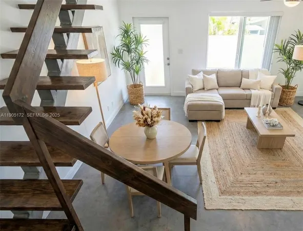 a living room with furniture or couch and a potted plant