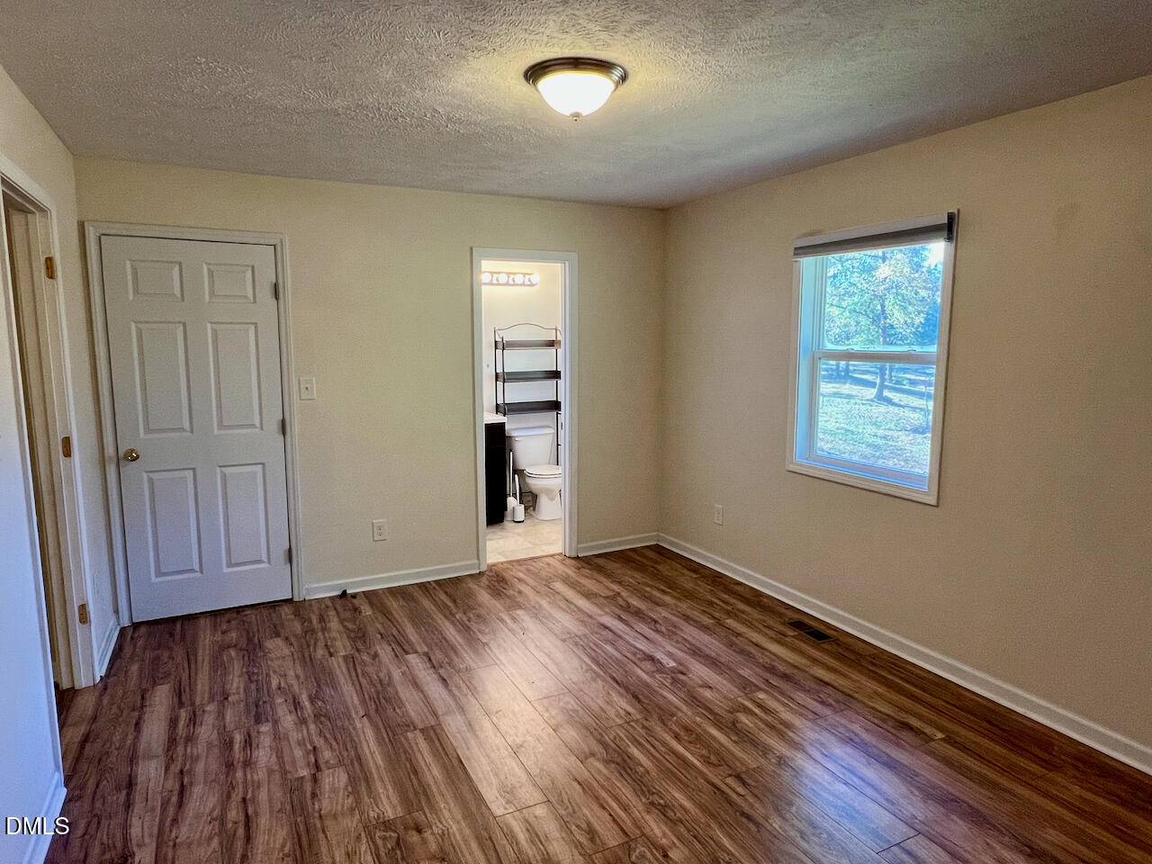 1421 Creech Road Garner, NC 27529 - Photo 11 of 22 wooden floor in an empty room with a window