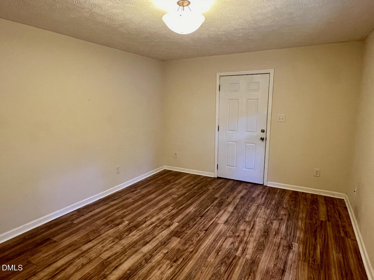 1421 Creech Road Garner, NC 27529 - Photo 12 of 22 a view of an empty room with wooden floor and a window