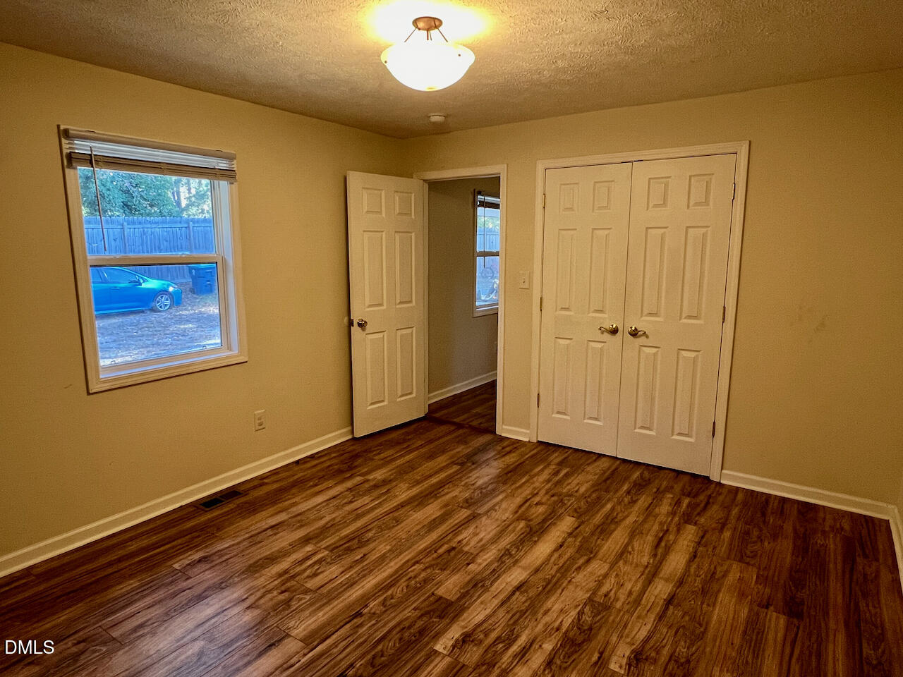1421 Creech Road Garner, NC 27529 - Photo 14 of 22 a view of an empty room with wooden floor and a window