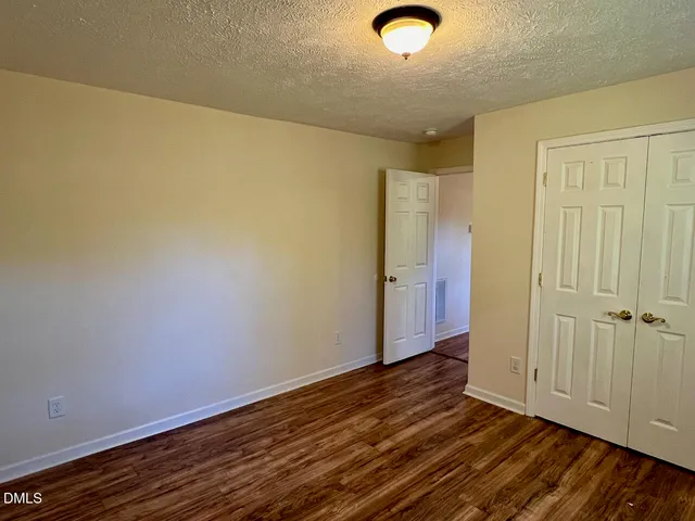 an empty room with wooden floor