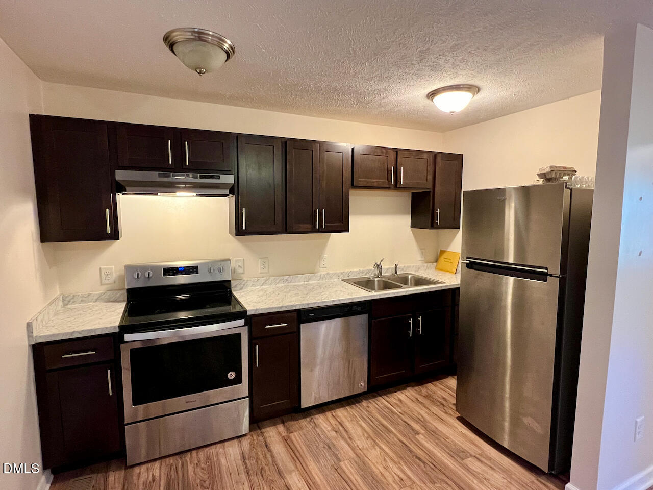 1421 Creech Road Garner, NC 27529 - Photo 5 of 22 a kitchen with stainless steel appliances a refrigerator sink and stove